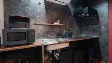 A modern kitchen with a microwave, sink, and built-in oven.
