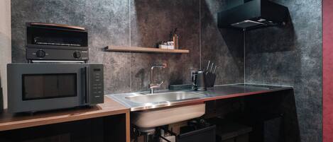A modern kitchen with a microwave, sink, and built-in oven.
