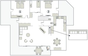 Grundriss eines Hotels mit zwei Schlafzimmern, einer Küche, einem Essbereich und einem kleinen Wohnzimmer.