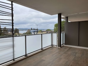 Enjoy breathtaking views of the water and distant hills from this balcony.