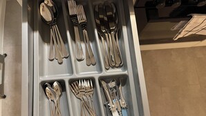 A drawer with neatly arranged cutlery including forks, spoons, and knives.