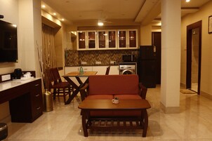 A modern kitchen with a dining area, including a sofa, table, and chairs.