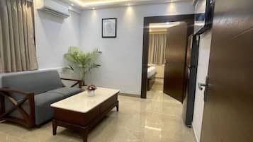 Superior Suite, City View | Living area | TV