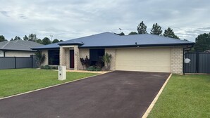 A single-story house with a garage, a front yard, and a driveway.