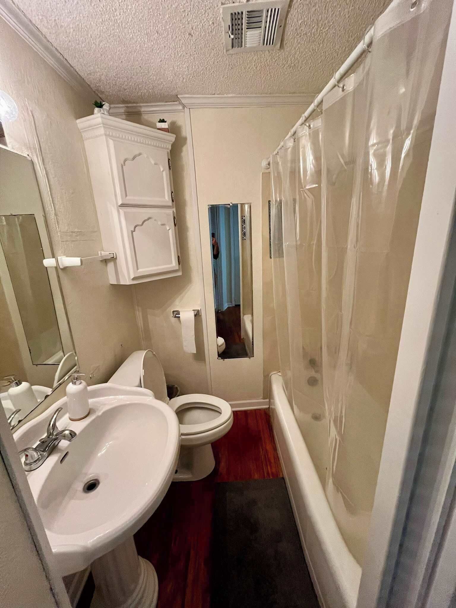 A bathroom with a sink, toilet, and bathtub.