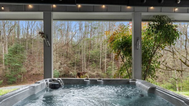 A hot tub with a view of a forest. - 3BR Gatlinburg*Firepit*Hot Tub*Privacy + Quiet! (Gatlinburg)