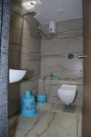 A bathroom with a marble floor, a white sink, a white toilet, and a showerhead. - HOTEL TOP 4  (Palanpur)