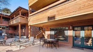A wooden building with outdoor seating and a staircase. - Fasching Haus 190 (Aspen)