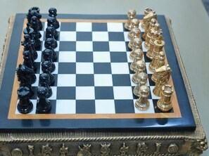 A chessboard with black and gold pieces.