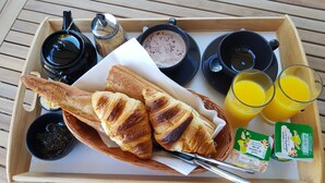 A tray with croissants, coffee, a hot drink, and orange juice. - Les Terrasses d'Arutoli (Porto-Vecchio)