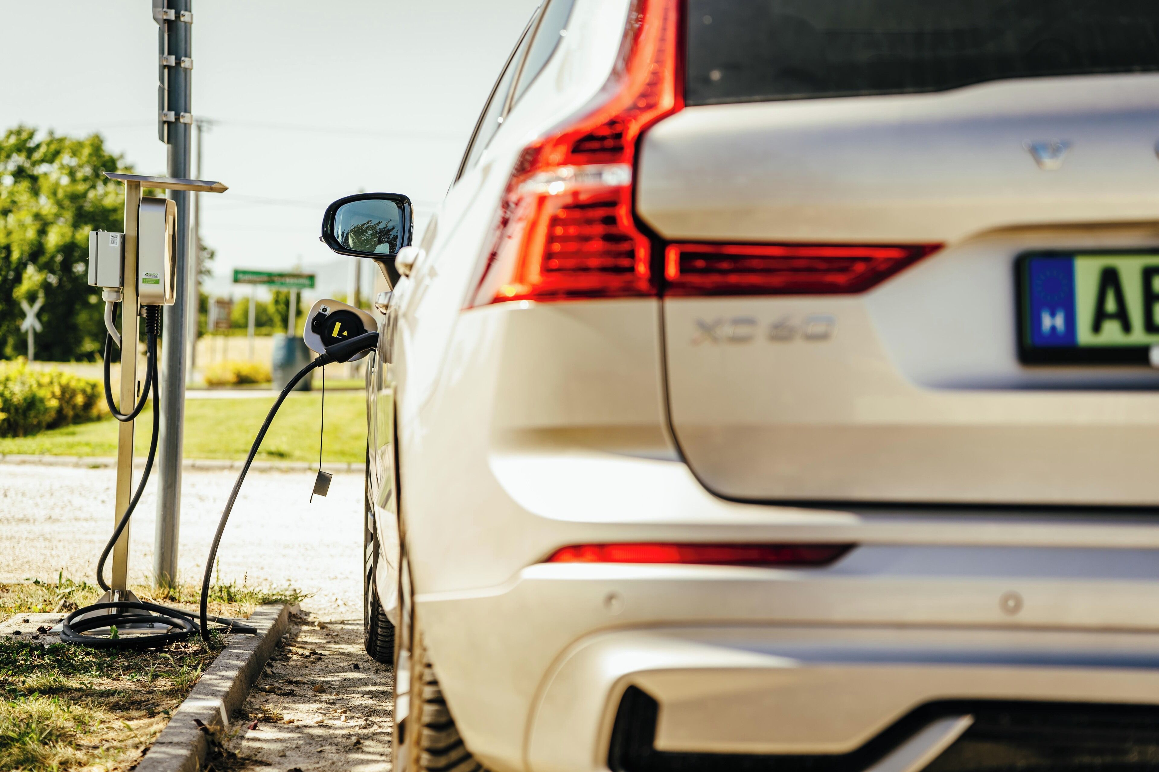 A white SUV parked at a charging station.