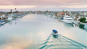 A marina with boats docked along the waterfront, surrounded by residential buildings. - Walk To Beach, Amazing Views, Private Jacuzzi* (Oxnard)