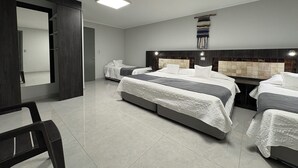 A modern hotel room with two beds, a large mirror, and a dark wood wardrobe. - Atankalama (Calama)