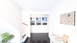 A modern interior with a staircase, a wall-mounted artwork, and a welcome sign. - Spacial Rend in Cape Woolamai (Cape Woolamai)