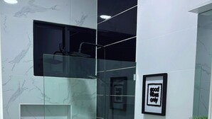A modern bathroom with a glass shower enclosure, a white toilet, and a vanity with drawers. - Elegant 2-bedroom villa oasis in Punta Cana with WiFi and AC (Punta Cana)