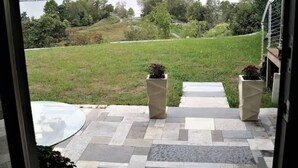 A patio with a view of a lake and hills. - Apartment with Expansive Views;  River & Mountains Walk to Train, Main St, DIA (Beacon)