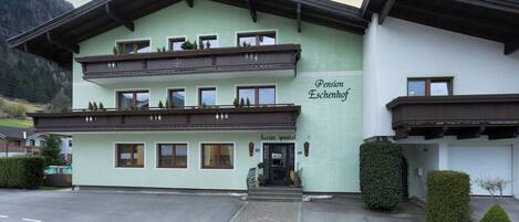 A multi-story building with a sign reading "Pension Eschenhof."