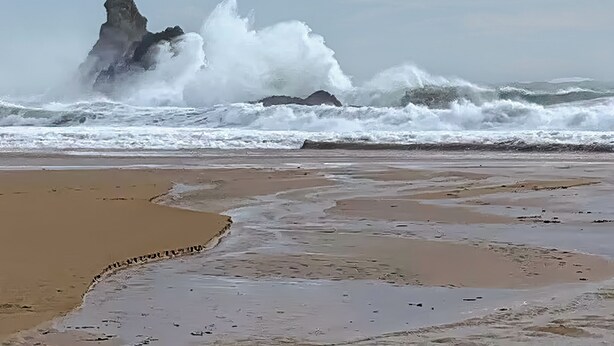 A beach with waves crashing against a rocky outcrop. - 3 bedroom accommodation in Castle Martin, near Pembroke (Castle Martin, near Pembroke)