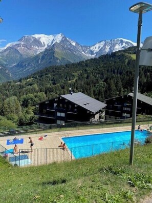 Relax by the serene pool surrounded by majestic mountains.