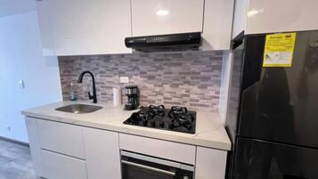 Microwave, coffee/tea maker, cookware/dishes/utensils, dining tables