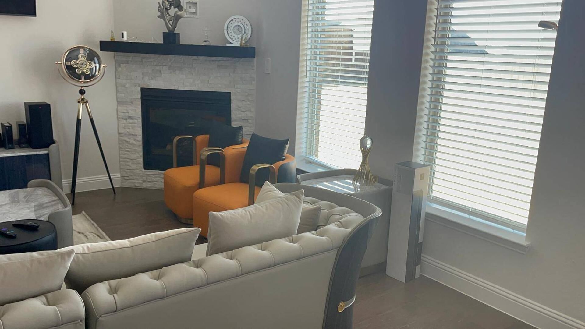 A living room with a fireplace, two armchairs, a sofa, and a coffee table.