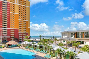 A hotel with a pool, beach view, and a pier in the background. - Calypso 3-309 - Gypsea's View (Panama City Beach)