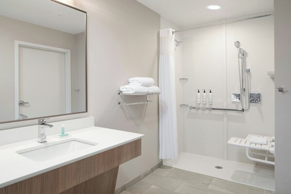 A modern bathroom with a white sink, mirror, and shower area. - Fairfield By Marriott Inn & Suites Piedmont Greenville (Piedmont)