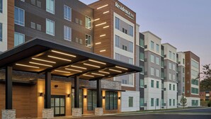 A multi-story hotel with a covered entrance, large windows, and a sign indicating it is a Marriott Residence Inn. - Residence Inn by Marriott Huntsville - Madison (Madison)