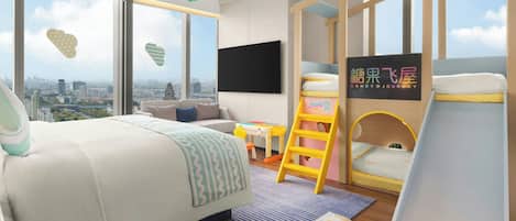 A modern bedroom with a large bed, a desk, a chair, a ladder, and a bunk bed.