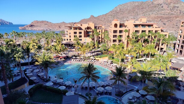A resort with multiple swimming pools, palm trees, and a mountainous backdrop. - Villa Del Palmar in Loreto, Luxurious Relaxation & Adventure, Resort Life (Loreto , B.C.S)
