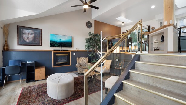 A spacious living area with a staircase, a dining area, and a kitchen. - Poolside Getaway with Spacious Outdoor Living & 6 Cozy Beds!! (Spokane)