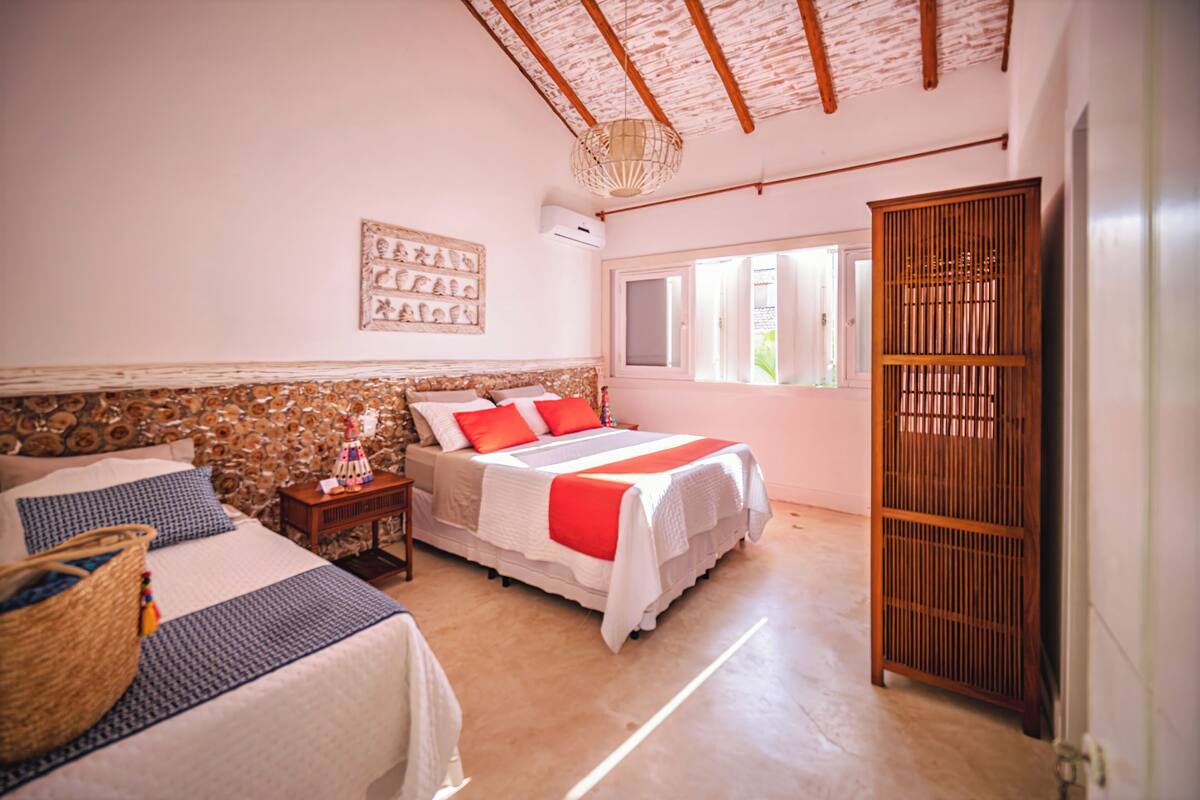 A bedroom with a bed, bedside table, and a wardrobe.