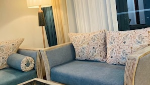 A modern living room with a sofa, a coffee table, and a lamp. - Monaara Leisure colombo 03 (Colombo)