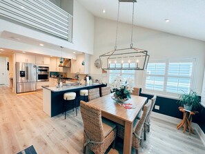 Enjoy cooking in this well-equipped kitchen with a central island, bar stools, and ample counter space.