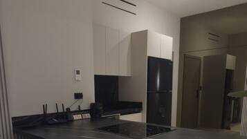 Una cucina moderna con isola centrale, sgabelli da bar ed elettrodomestici integrati.