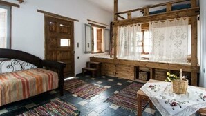 A rustic room with a bed, wooden beams, a window with lace curtains, and a small table with a basket. - Entire Villa in Kalymnos, Greece
5 guests1 bedroom3 beds1.5 bathrooms (Kalymnos)