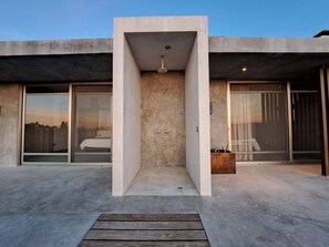 A modern building with a central courtyard, large sliding glass doors, and a minimalist design. - Arroyo Escondido -Luxe Oceanview Contemporary Home (Todos Santos)
