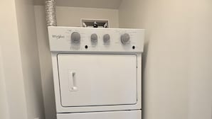A stacked washer and dryer unit in a laundry room. - Modern Whitby 3 Bedroom Condo, close to the 401, Trafalgar Castle and Toronto! (Whitby)