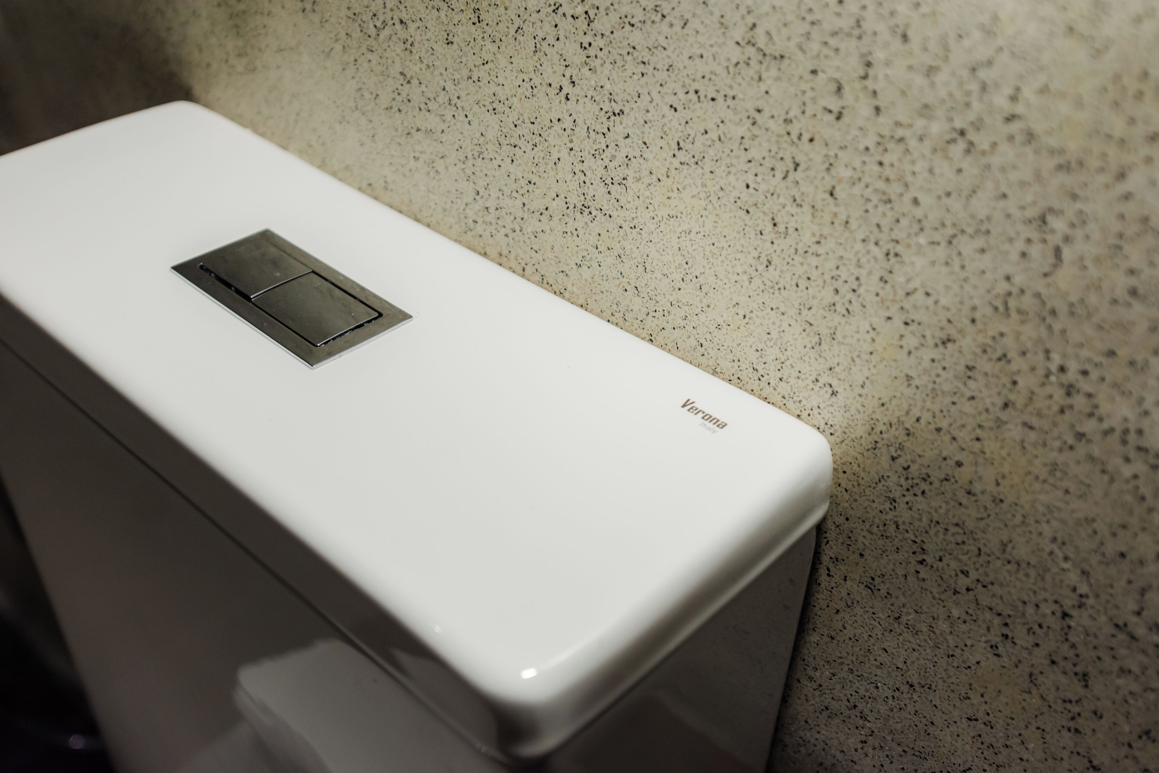 A white, rectangular object with a small, square, metallic panel and the word "Verona" on its side.
