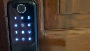 A keypad door lock on a wooden door. - Master Suite Platinum #1 (San Pedro Sula)