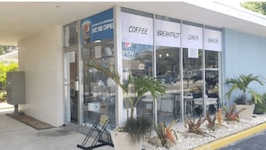 A commercial building with a coffee shop, breakfast, lunch, and bakery services.