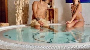A man and a woman sitting in a hot tub with a blue wall and a wooden shelf in the background. - [2] Blue Summer Vibes Mini Studio, A/C, parking, 50m from beach, SPA access (La Ciotat)