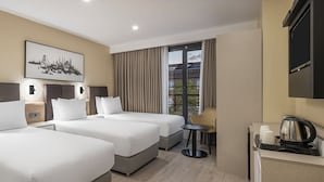 A hotel room with two beds, a desk with a telephone, a coffee maker, and a window with curtains. - Garner Hotel Istanbul - Airport Arnavutkoy by IHG (Arnavutköy)
