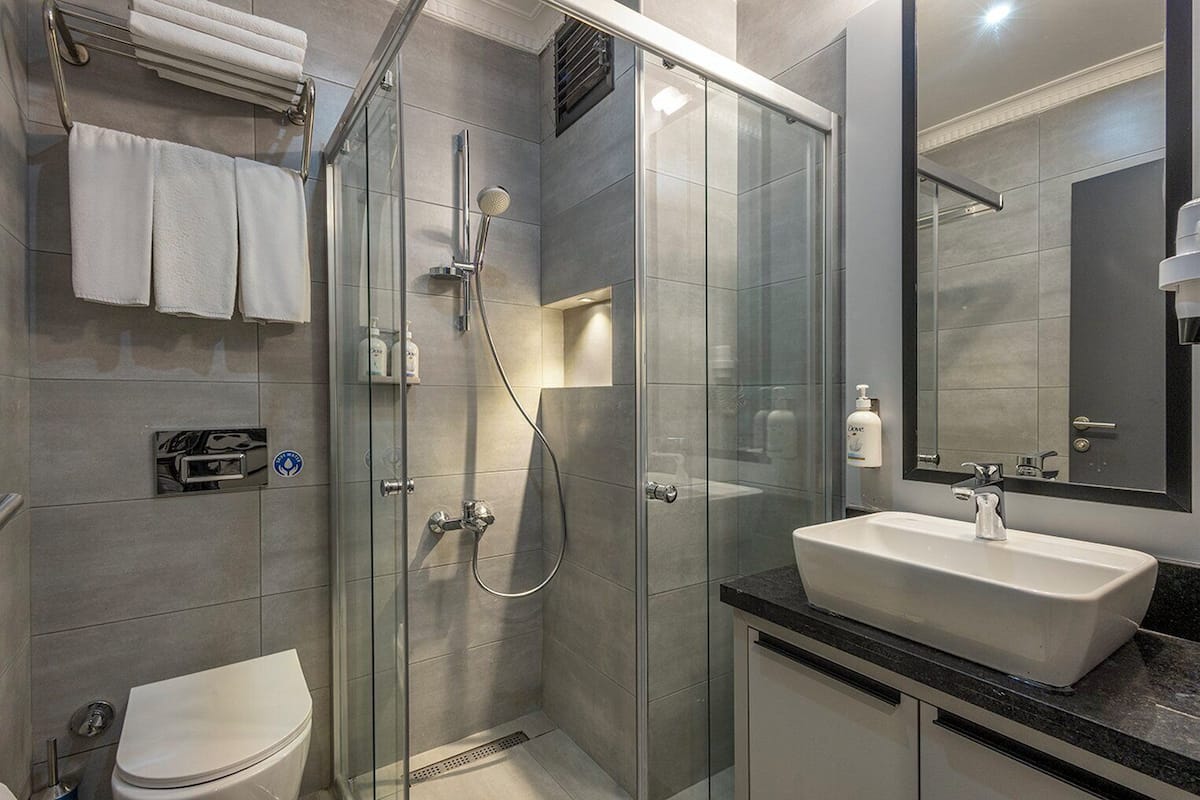 Premium Room, Multiple Beds | Bathroom | Shower, free toiletries, hair dryer, slippers