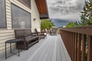 A wooden deck with a bench, chairs, and a table. - Peakview Lodge - Wood Burning Stove-Gorgeous Views (Prescott)
