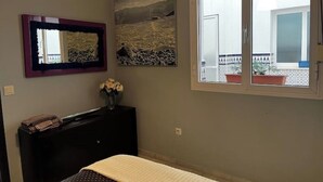 A bedroom with a bed, a dresser, a mirror, and a window. - Apartment in Centro de Ronda, dream city (Ronda)