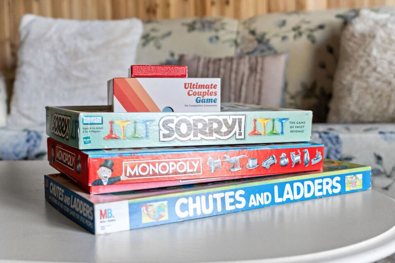 A stack of board games on a table.