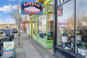 Une devanture de magasin aux couleurs vives, avec une enseigne indiquant « Little Griddle » et un panneau signalant une limite de vitesse de 20.