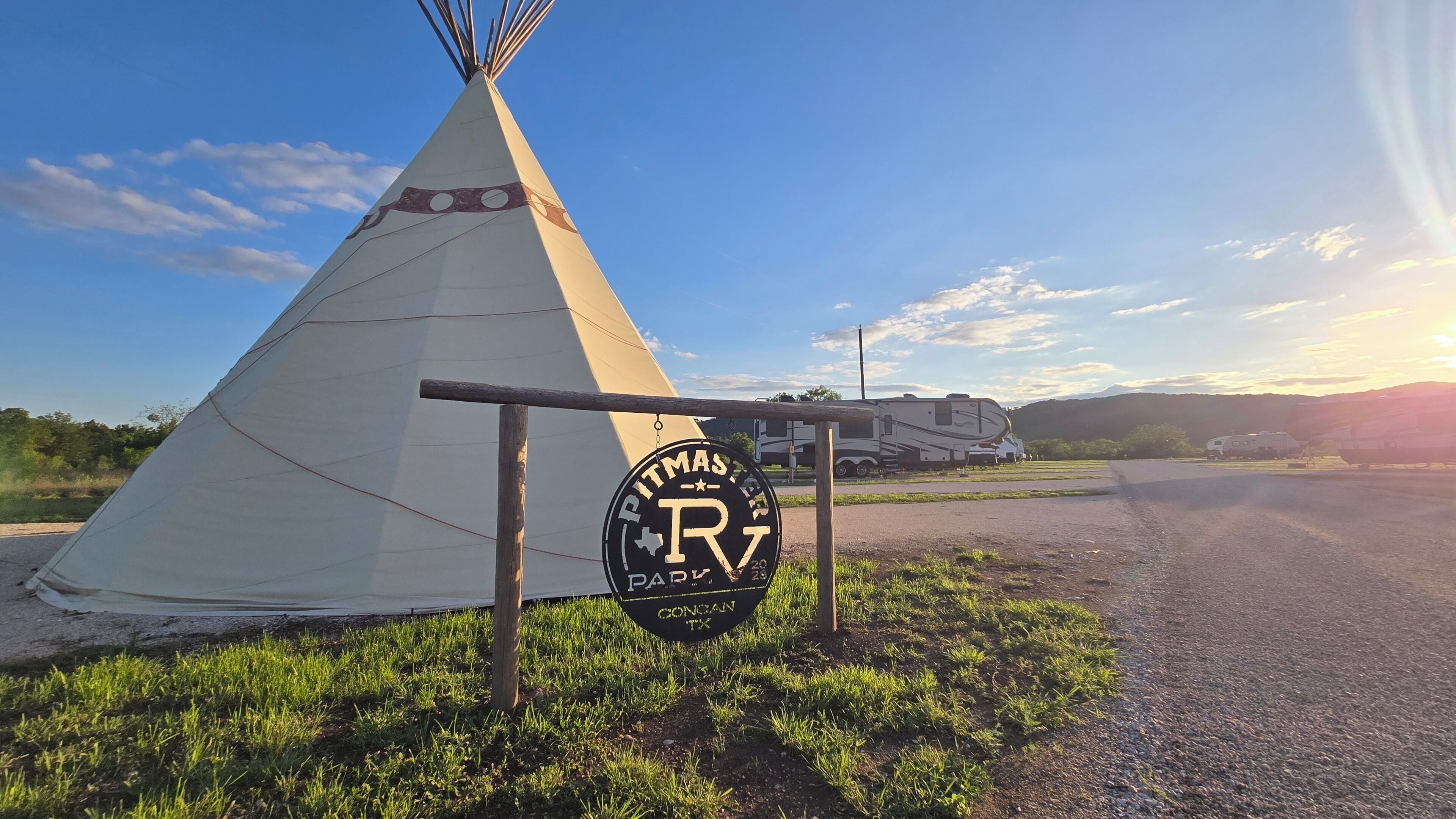 A teepee with a sign indicating a Pitmaster RV Park in Concan, TX.