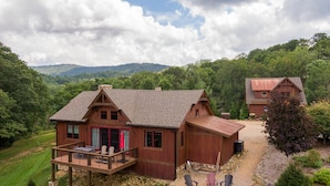 A wooden cabin with a deck, a fire pit, and outdoor seating. - Sommer Hus at Eagles Nest: Pet Friendly Single Level (Banner Elk)